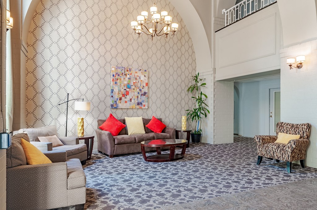 a living room with couches and chairs and a chandelier