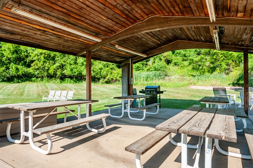 a picnic pavilion with benches and tables