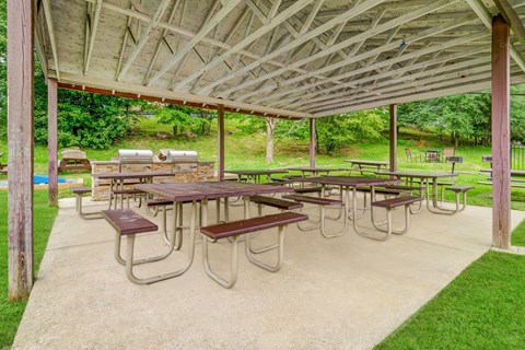 a group of picnic tables under a pavilion