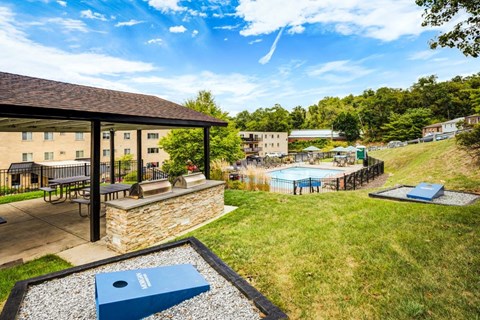 A sunny day at a resort with a pool and a building in the background.