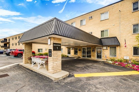 A building with a black roof and a sign that says "BUILDING 1" is shown.