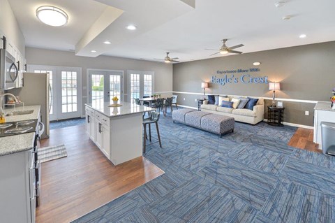 a large living room with a kitchen and a couch