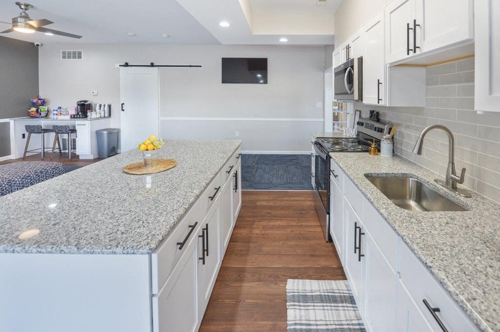 a kitchen with white cabinets and a sink
