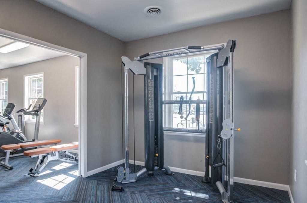 a gym with exercise equipment and a window
