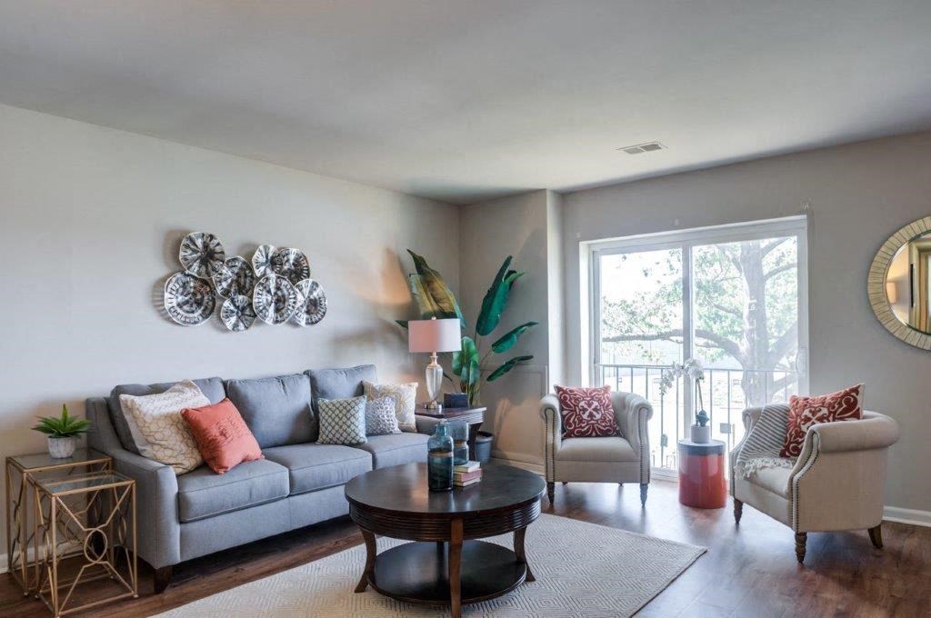 a living room with a couch and chairs and a table