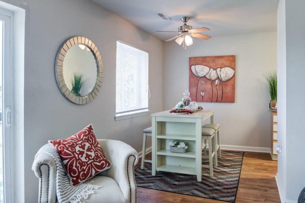 a living room with a couch and a table and a mirror