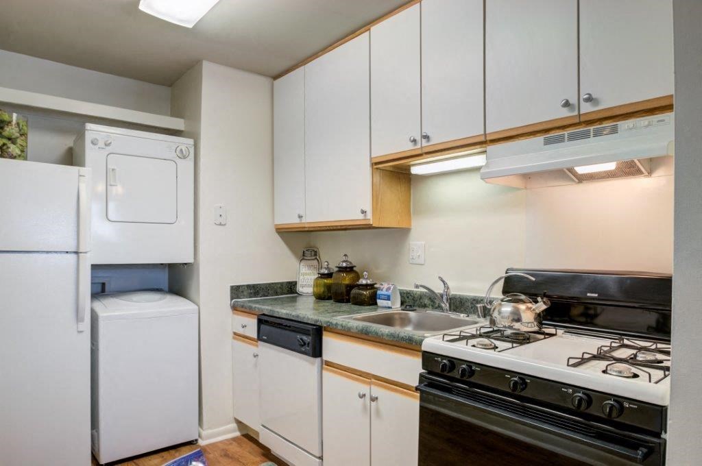 a small kitchen with a stove refrigerator and sink