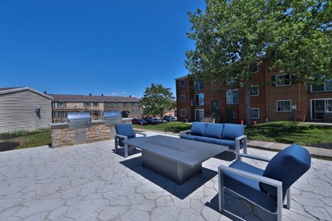 a large patio with furniture and a fire pit