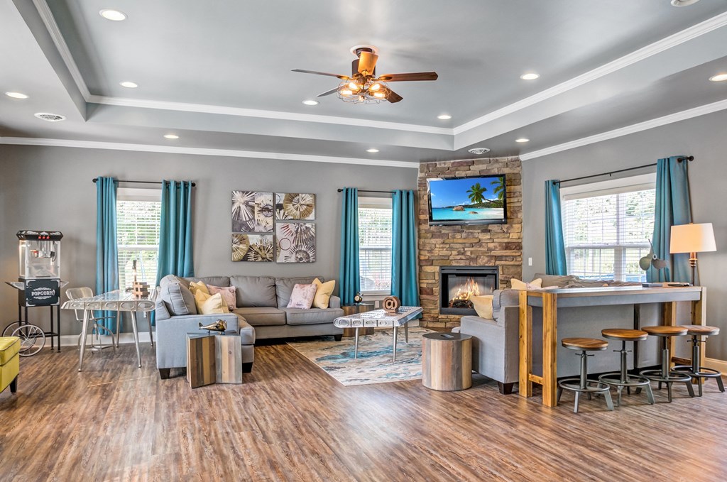 a living room with a couch and a bar and a ceiling fan