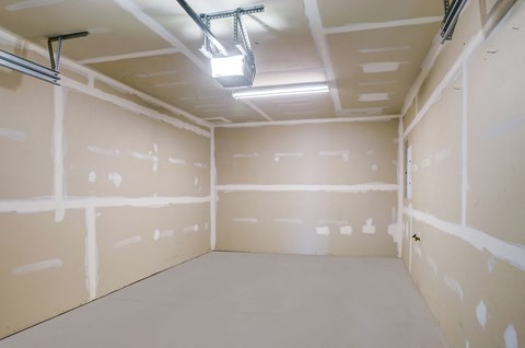 a room with plaster walls and a light on the ceiling