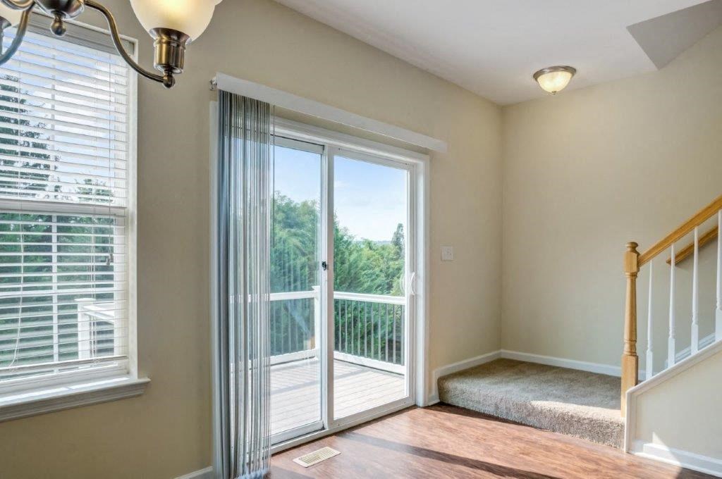a living room with a sliding glass door to a balcony