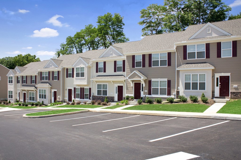a row of townhouses with a parking lot in front of them