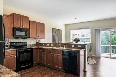 a kitchen with wooden cabinets and a stove and a sink