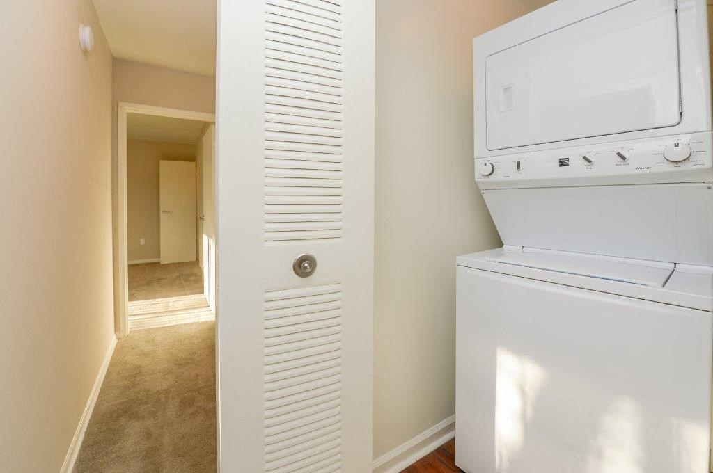 a white laundry room with a washer and dryer in it