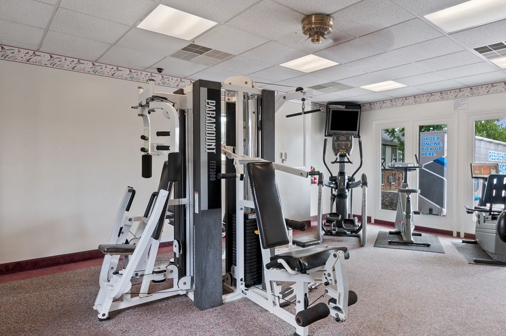 a gym with weights and other exercise equipments in a room