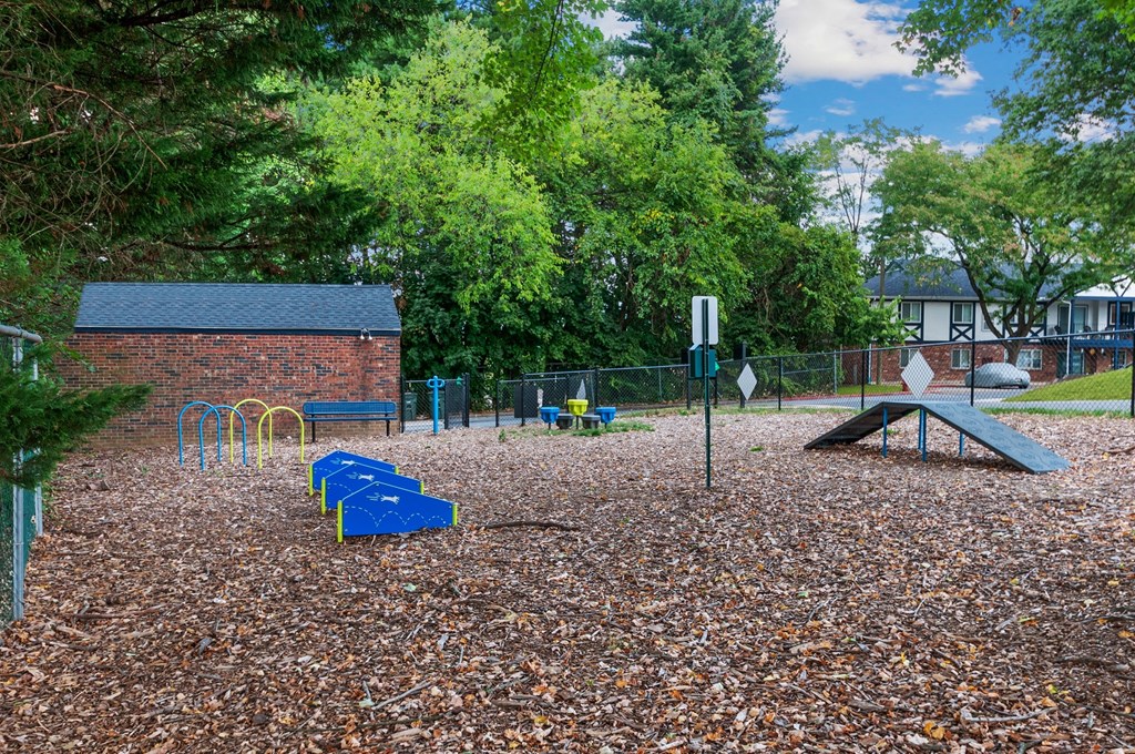 a playground with benches and a sign in a park
