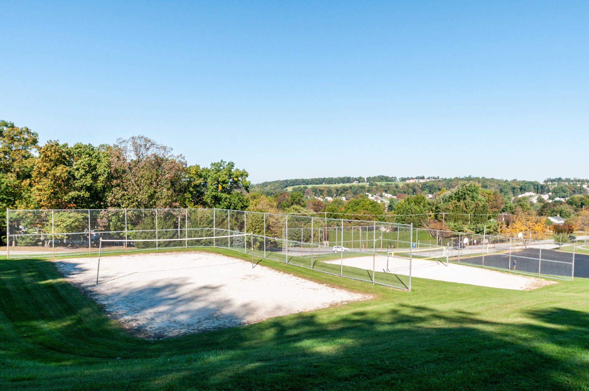 a tennis court with a city in the background