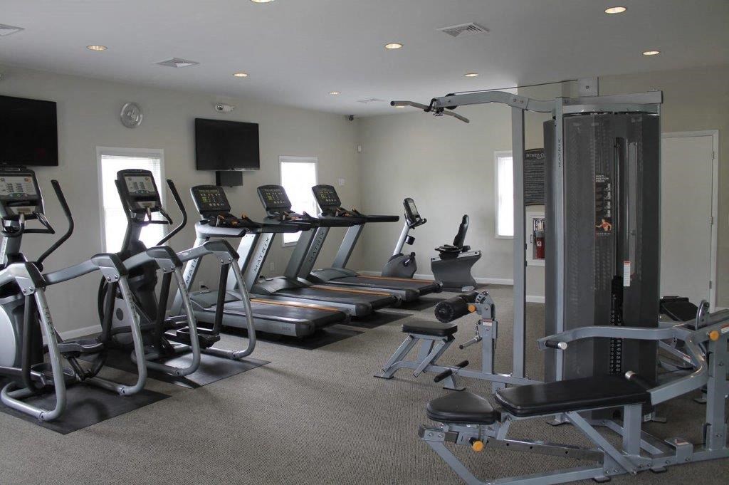 a gym with a lot of machines and weights