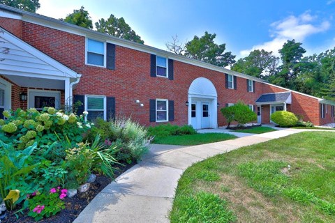 a brick building with a sidewalk in front of it
