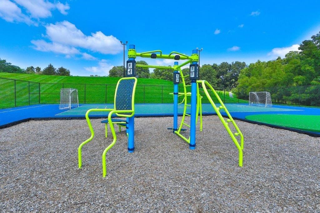 a playground with a blue and yellow swing set