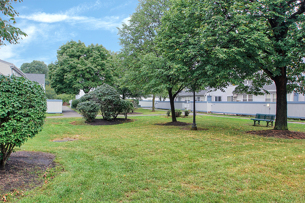 exterior of apartments with trees and green space