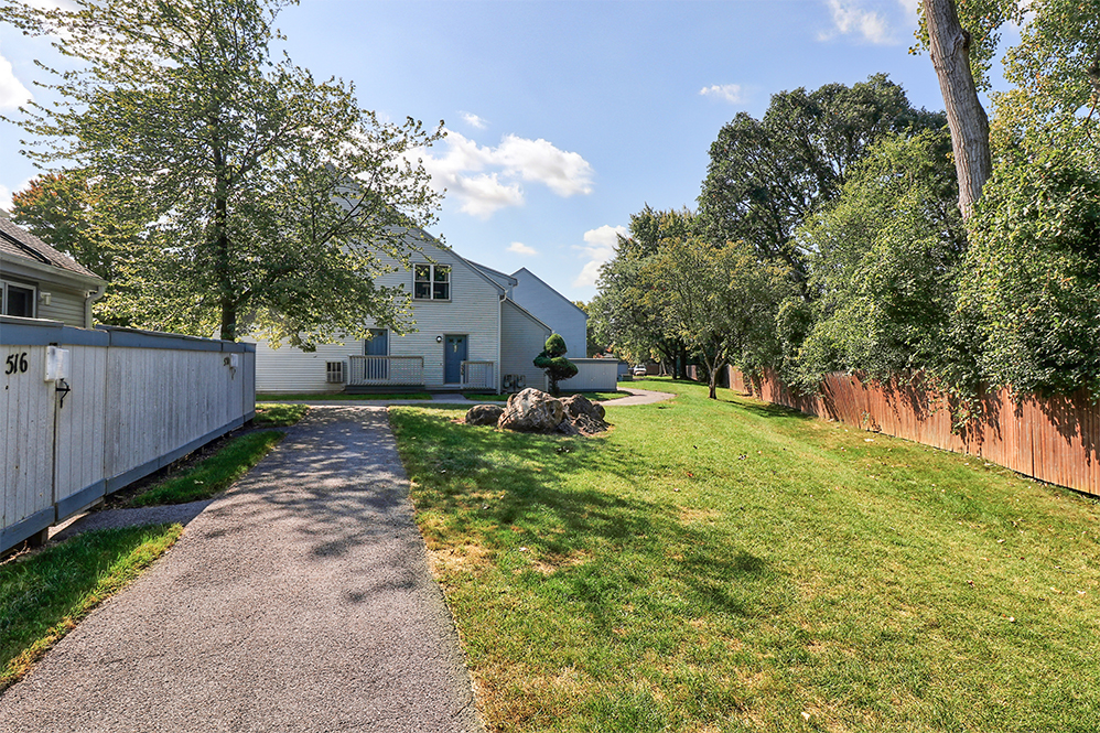 exterior of apartments with trees and green space