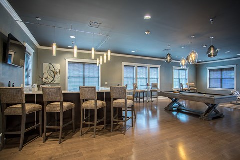a game room with a pool table and a bar