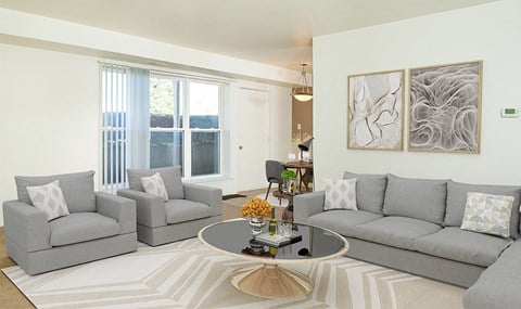 a living room with two gray couches and a coffee table