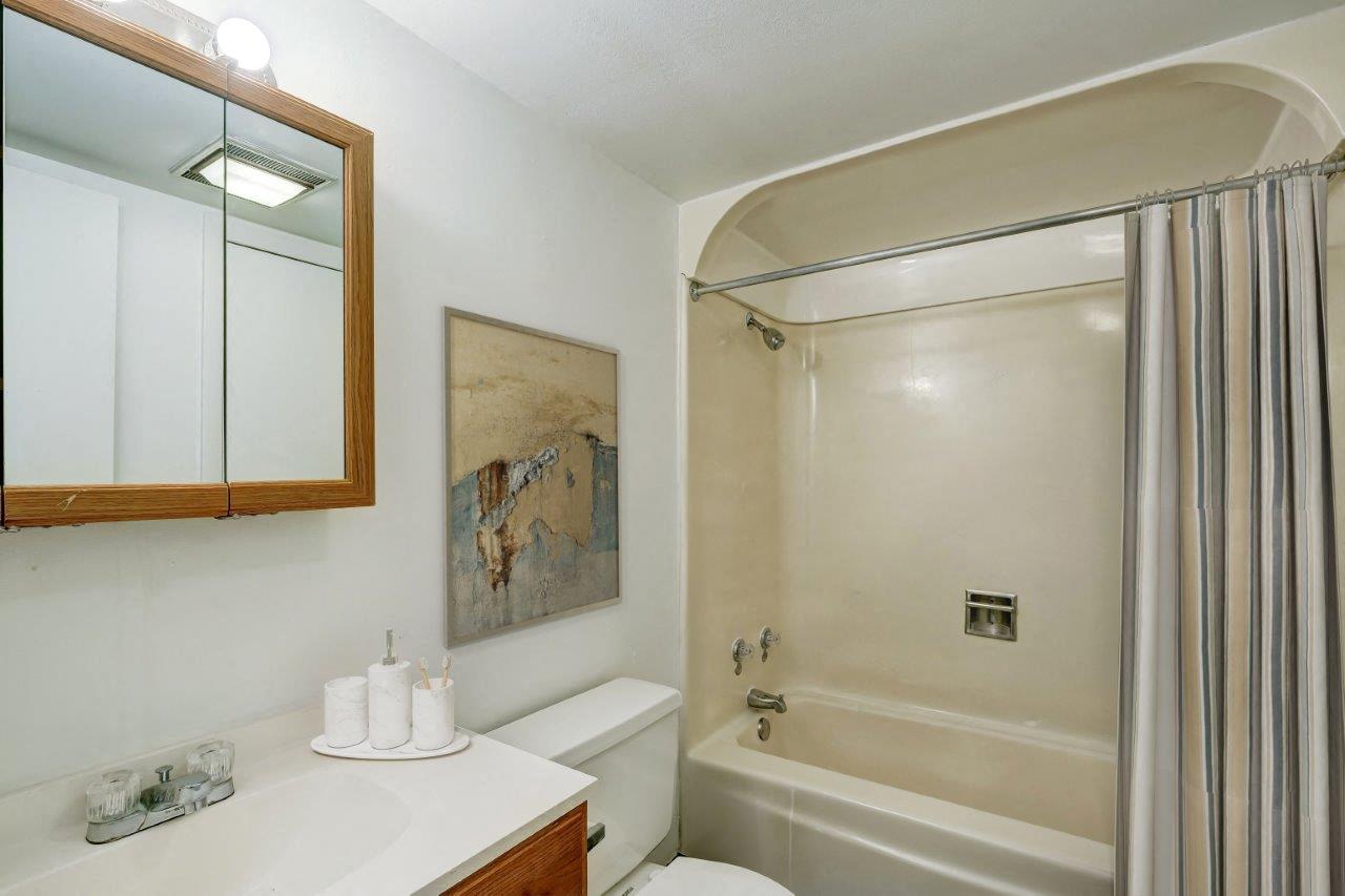 a bathroom with a shower and a sink and a toilet