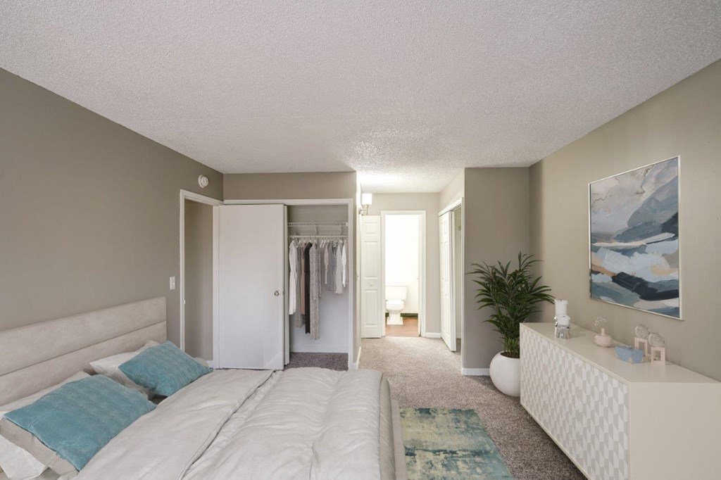 a bedroom with a large bed and a closet