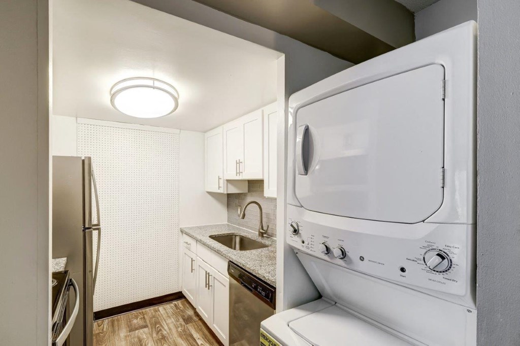a kitchen with a washer and dryer and a refrigerator