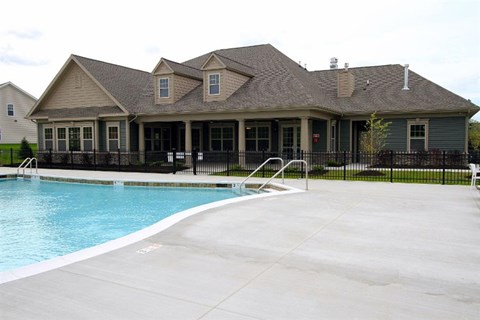 A house with a pool in front.