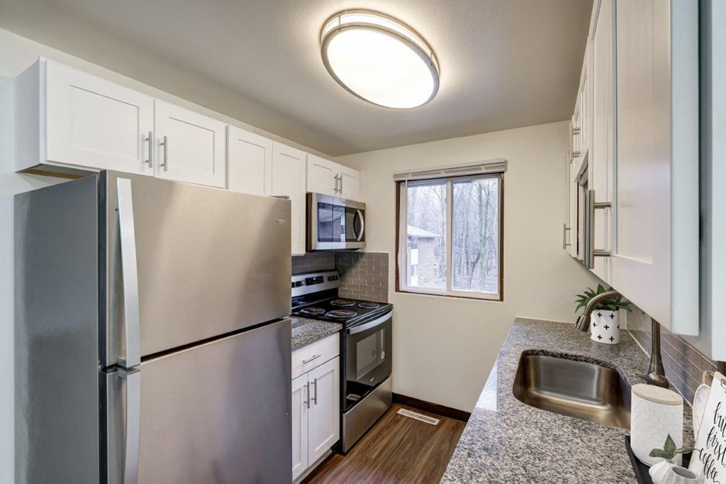 a kitchen with stainless steel appliances and granite counter tops