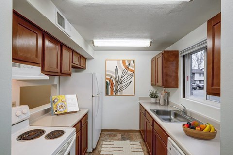 a kitchen with white appliances and wooden cabinets