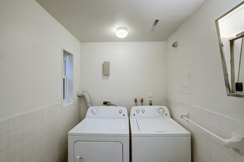 a laundry room with two washes and a dryer