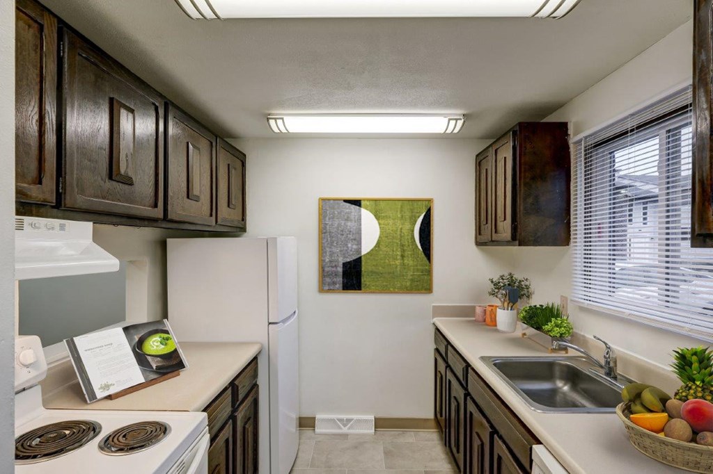 a kitchen with a sink and a refrigerator