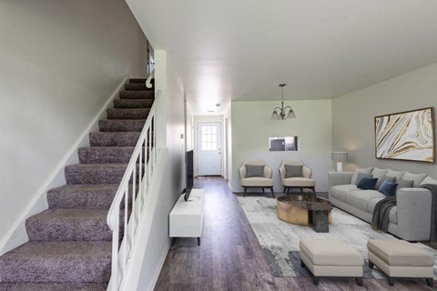 a living room with a staircase and a couch