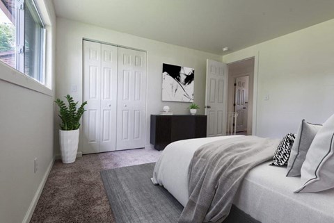 a bedroom with a bed and a potted plant