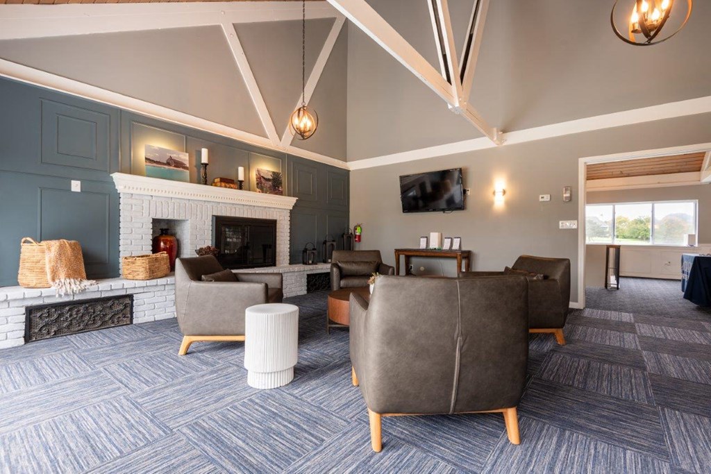 a large living room with couches and a fireplace