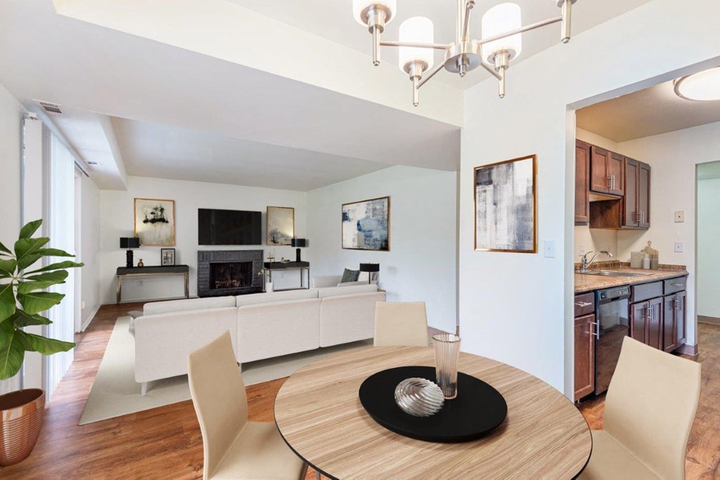 a dining room and living room with a table and chairs
