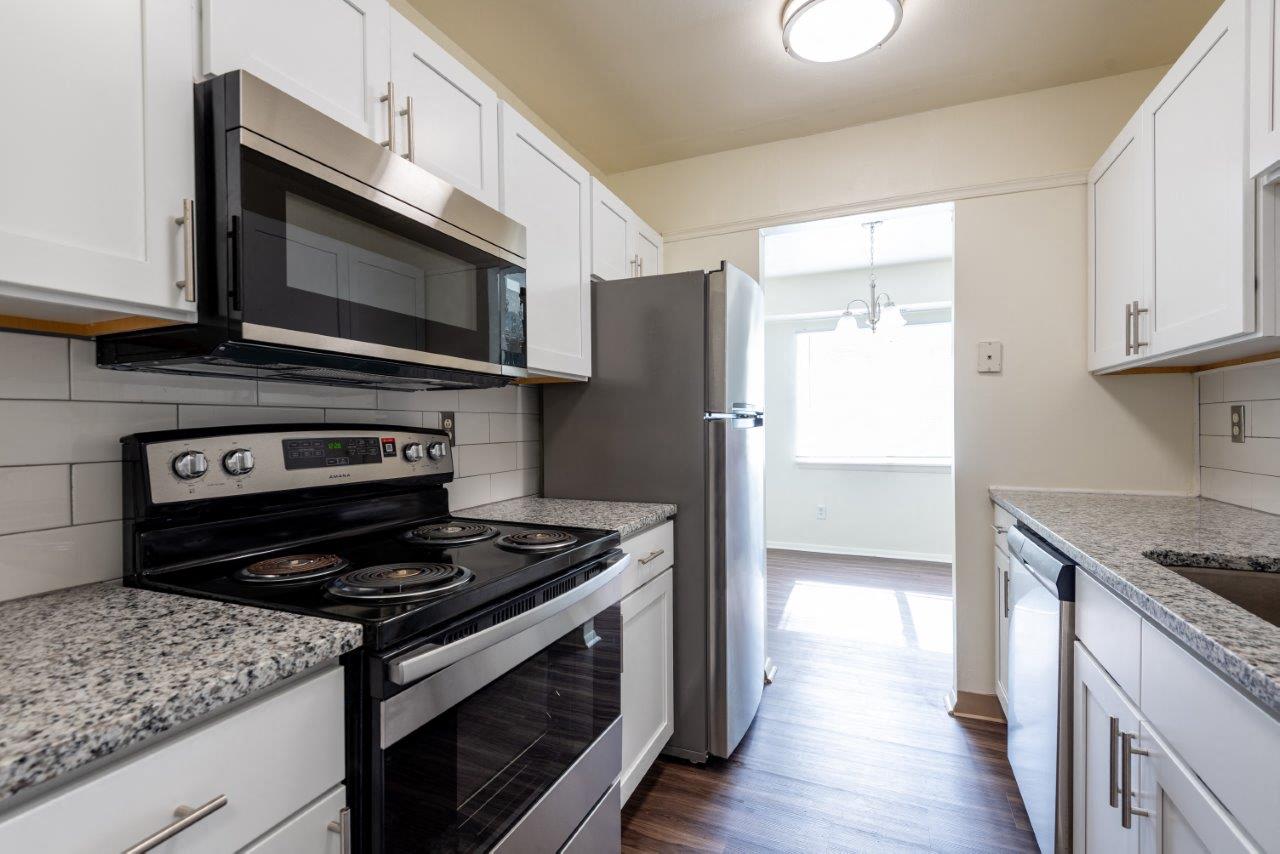 a kitchen with a stove and a microwave and a refrigerator