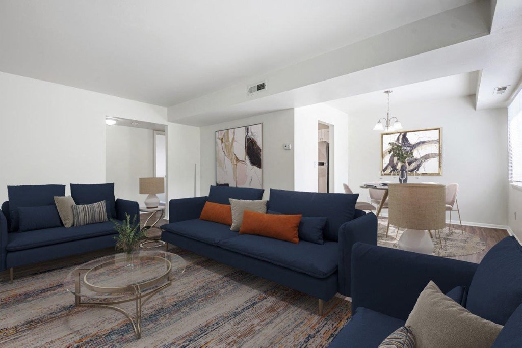 a living room with blue couches and a table
