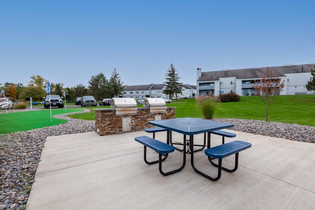 our apartments have a patio with a picnic table and a grill
