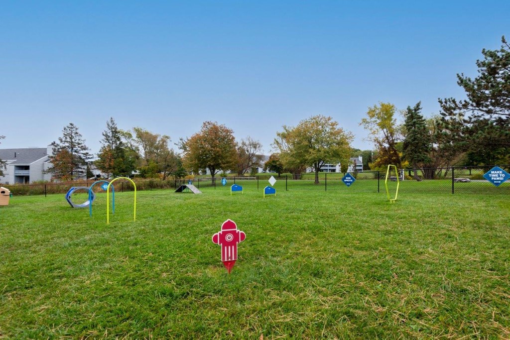 a red fire hydrant in the middle of a field