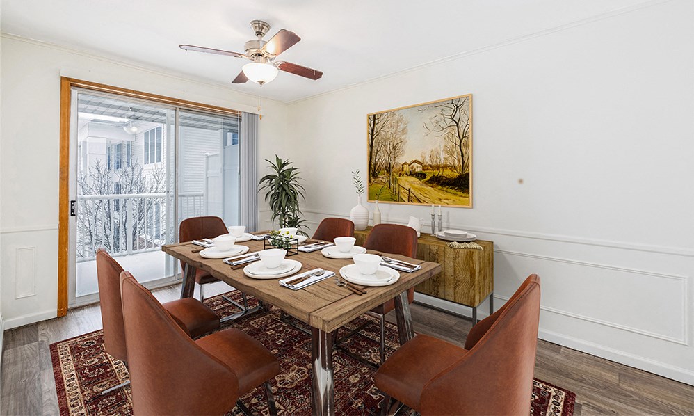 a dining room with a wooden table and chairs and a ceiling fan