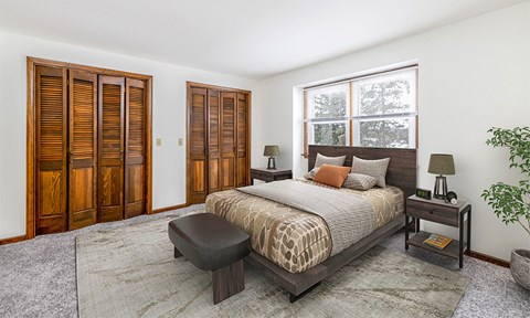 a bedroom with a bed and two wooden doors