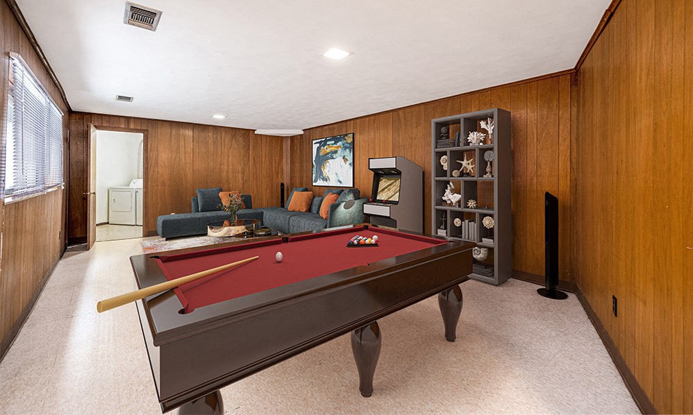 a game room with a pool table and a tv