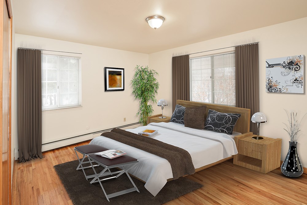 a bedroom with a bed and two windows