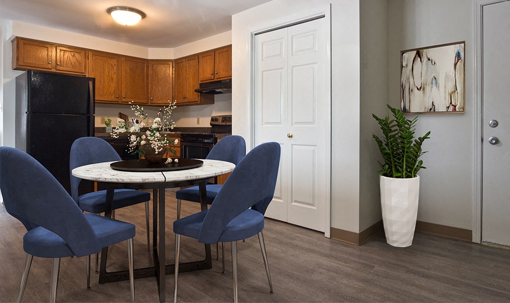 a dining room with a table and chairs and a kitchen