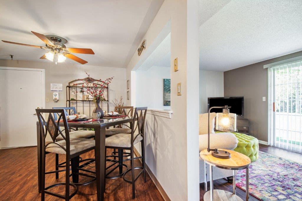 a dining room and living room with a table and chairs